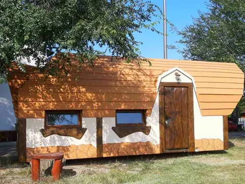 Warm wooden cottage with a bench by the door